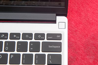 The fingerprint sensor on the Framework Laptop on top of a red tablecloth.